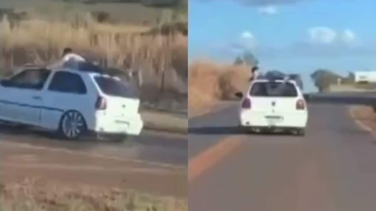 V Deo Mostra Homem Deitado Em Teto De Carro Em Movimento Na Br Em